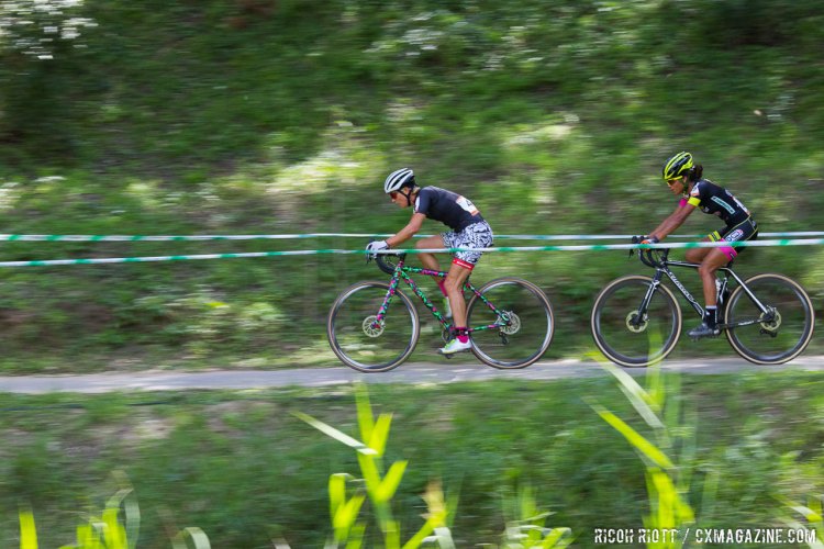 Emily Kachorek (Squid Bikes, USA) leads Ceylin Alvarado (Kleur Op Maat - No Drugs, Netherlands) along the river bank. Qiansen Trophy Race #1, China. © R. Riott / Cyclocross Magazine