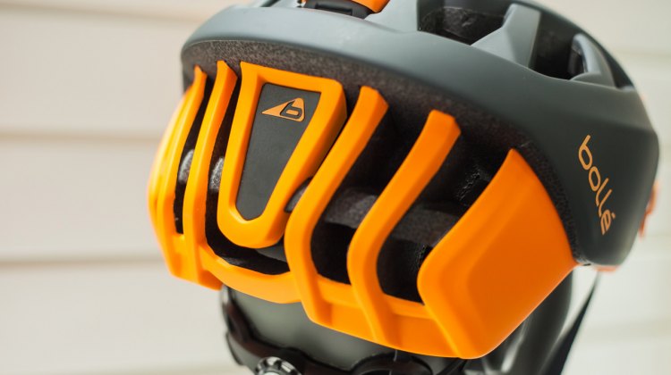 The helmet is offered in numerous colorways, including this black and orange finish shown here. The triangular panel on the back of the helmet pops out to make way for a rear light. © Cyclocross Magazine