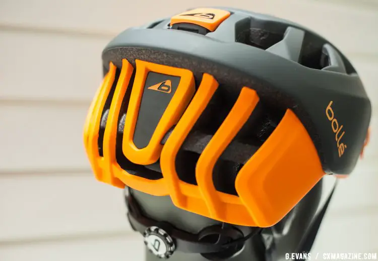 The helmet is offered in numerous colorways, including this black and orange finish shown here. The triangular panel on the back of the helmet pops out to make way for a rear light. © Cyclocross Magazine