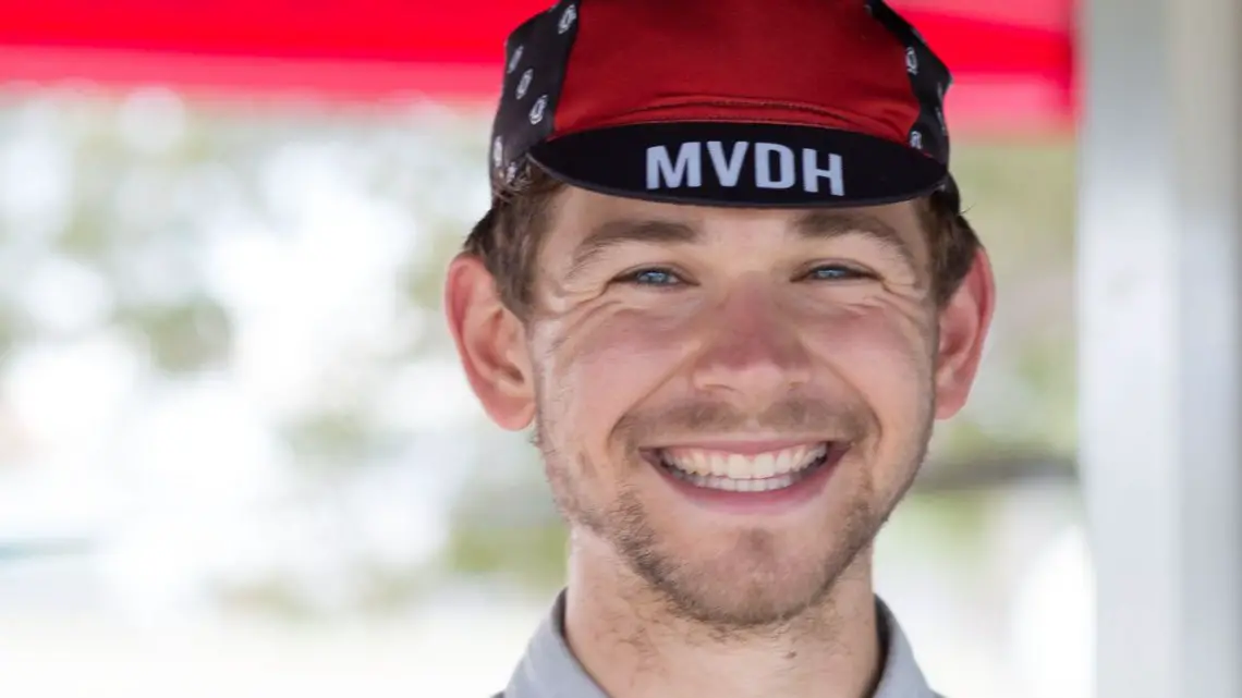 Michael Van den Ham is all smiles modeling his cap. You can own one too, as it's one way he funds his European race travel. © Cyclocross Magazine