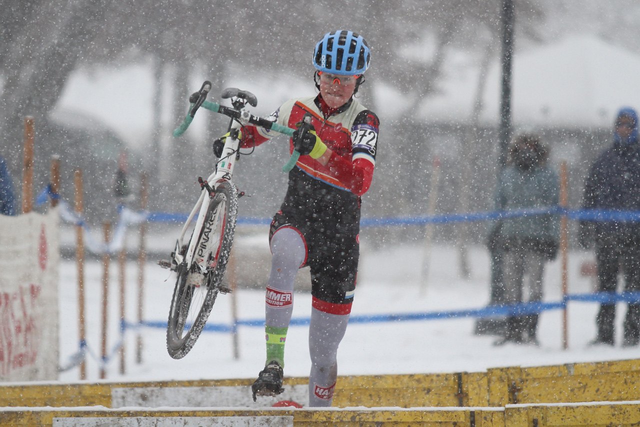 Ava Lilley (unattached) navigates the barrier section and leaps into third. © D. Mable / Cyclocross Magazine