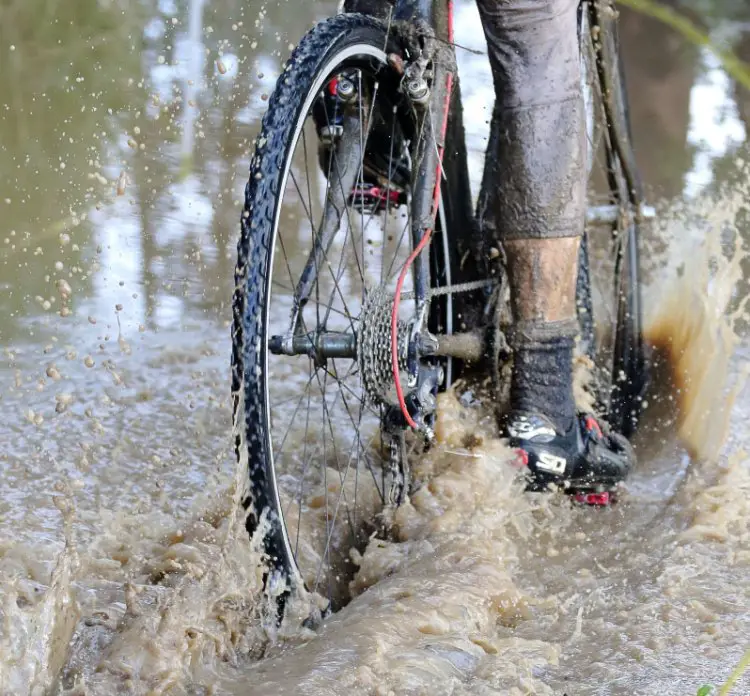 Standing water after heavy rains presents challenges, but beats sitting on a dry couch. Rockville Bike Cyclocross Series, Solano Community College. © John Silva