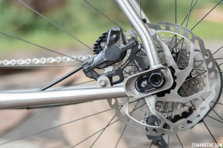 The rear brake caliper moves with the axle as you switch between the two separate positions, but wheel removal for flats isn't tool free. Otso Cycle Warakin stainless steel gravel/cyclocross bike. © Cyclocross Magazine