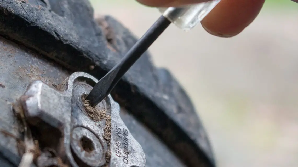 An eyeglass screwdriver makes a great tool for cleaning the cleat bolt's hex socket. Tips to remove stuck cleat bolts of SPD or other mountain bike pedals. © Cyclocross Magazine