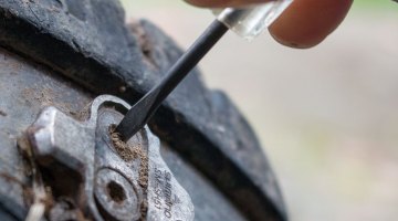 An eyeglass screwdriver makes a great tool for cleaning the cleat bolt's hex socket. Tips to remove stuck cleat bolts of SPD or other mountain bike pedals. © Cyclocross Magazine