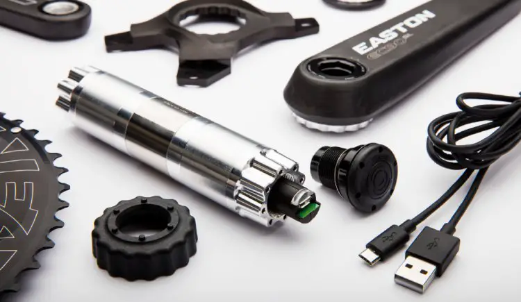 A detailed view of the CINCH Power Meter spindle, caps, charging cable, spider, rings and cranks.