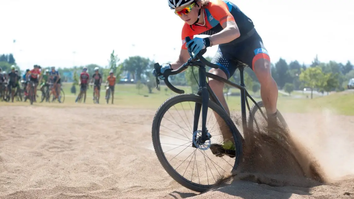 Kelton Williams digs in on his way to the sand hairpin turn. 2017 Montana Cross Camp © Cyclocross Magazine