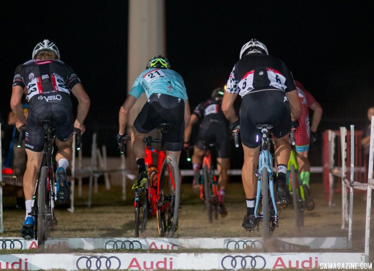 Chasers go three-wide to hop the small, sandy stairs at the back of the course. 2017 CrossVegas Elite Men. © A. Yee / Cyclocross Magazine
