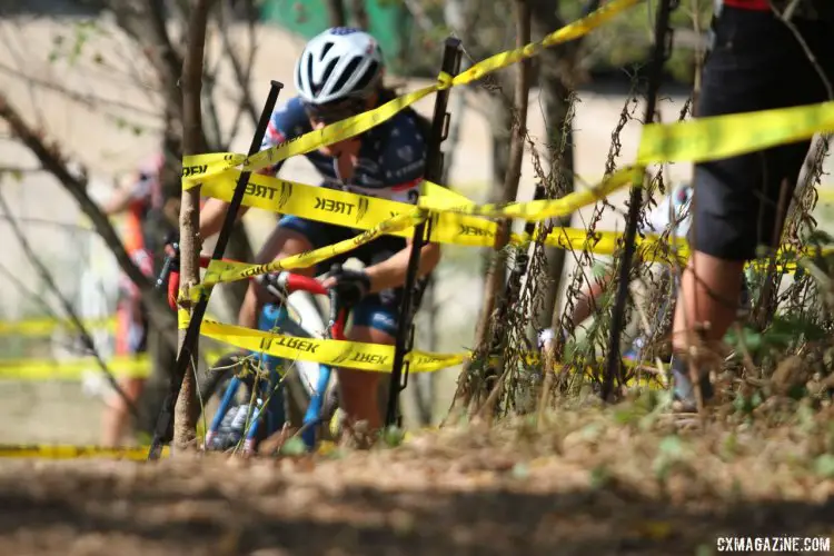 With the Trek factory in the background, and yellow tape in front, Katie Compton climbs her way through the woods to the top of Junkyard Hill during Friday's C2 race at the Trek CX Cup. © D. Mable / cxmagazine.com