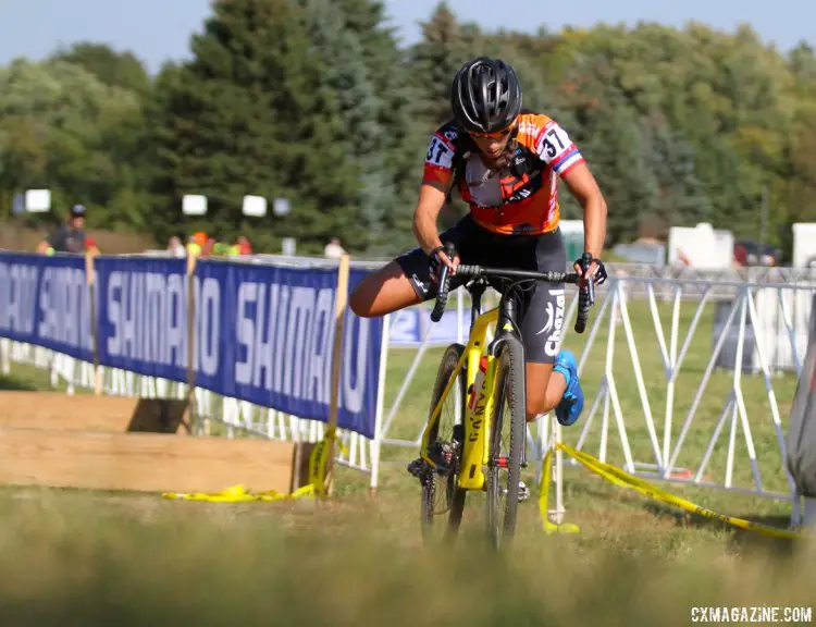 Lucie Chainel hops aboard her yellow steed after running the barriers during Friday's C2 race at the Trek CX Cup. © D. Mable / cxmagazine.com