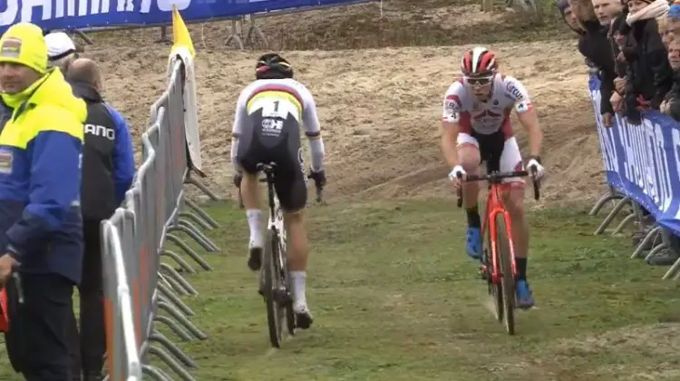 Wout van Aert returns to the pit as Laurens Sweeck rides by. 2017 World Cup Koksijde. Screen capture.