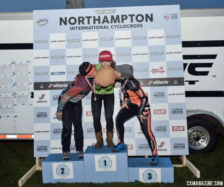 The Women's podium of White, Fahringer and Kemmerer celebrates with the traditional eating of the cookie. 2017 Northampton International Day 1. © Chris McIntosh