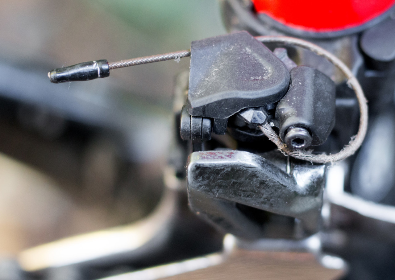 The Shimano DuraAce 9100 front derailleur features a plastic cap that