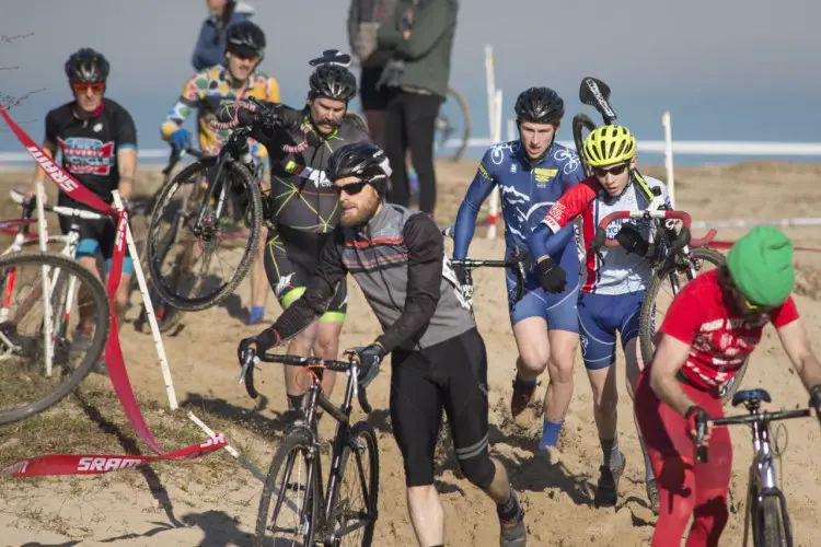 Race leaders Peter Swinand and Luke Stover navigate through the fluffy sand as well as competitors in the single speed field. There are several races in the Chicago Cross Cup with combined fields to maximize course usage. 2017 Chicago Cross Cup #11, Montrose Harbor Illinois State Championships. © 2017 Matthew Gilson