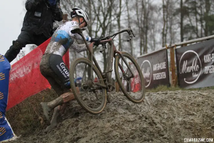 Mathieu van der Poel runs up a muddy incline while one of Hazen's fellow photographers gets an interesting view. 2018 GP Sven Nys Baal. © B. Hazen / Cyclocross Magazine