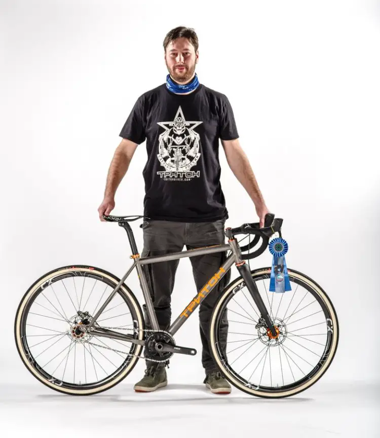 Demitry Nechaev of Triton Bicycles poses with his Best Cyclocross Bike Award-winning titanium singlespeed. 2018 North American Handmade Bike Show. photo: NAHBS