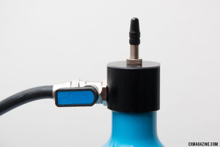 Once you fill the canister and attach the hose to your tire valve, you just flip this blue switch the unleash the blast of air. Airshot LTD tubeless compressor / canister. © Cyclocross Magazine