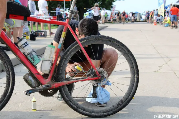 Chain lube was a must-have at the checkpoints. A pit crew member lubes his rider's bike up at Checkpoint 1. 2018 Dirty Kanza 200. © Z. Schuster / Cyclocross Magazine