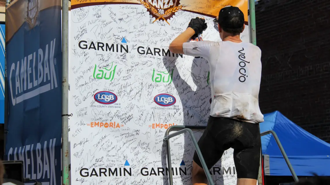 Ted King adds his finisher signature after his second DK200 win. He signed it "Dirtiest Kanza Yet." 2018 Men's Dirty Kanza 200. © Z. Schuster / Cyclocross Magazine