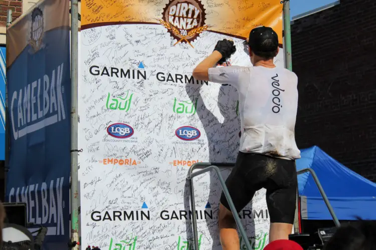 Ted King adds his finisher signature after his second DK200 win. He signed it "Dirtiest Kanza Yet." 2018 Men's Dirty Kanza 200. © Z. Schuster / Cyclocross Magazine