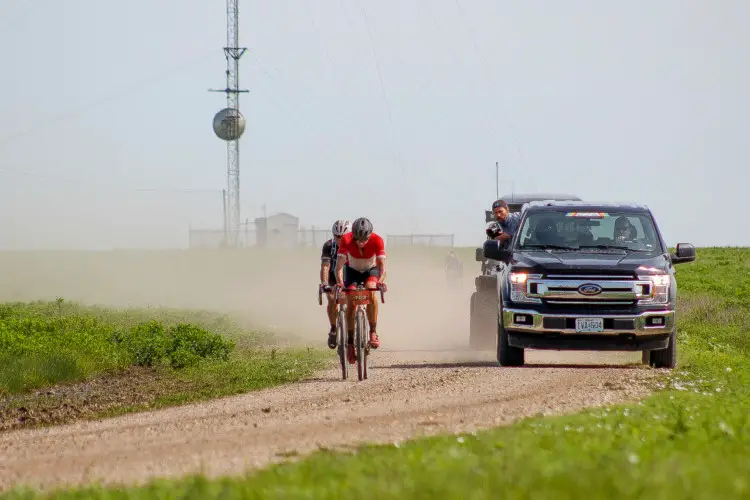 Nys had to chase back after his flats, towing a camera crew and the occasional lucky rider. 2018 Men's Dirty Kanza 200. © Z. Schuster / Cyclocross Magazine