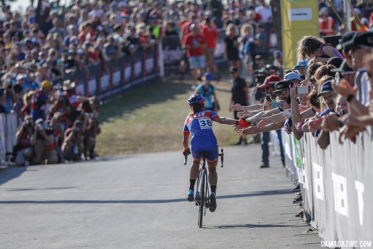 Katerina Nash gives out high fives after her third-place finish. 2018 World Cup Waterloo. © R. Clark / Cyclocross Magazine