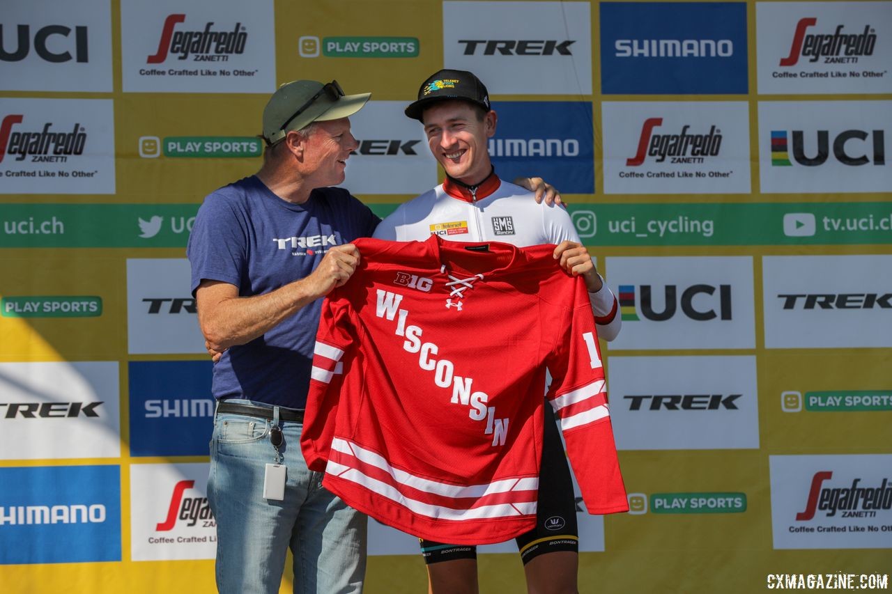 Trek's John Burke presents Toon Aerts with a Wisconsin hockey jersey podium prize. 2018 World Cup Waterloo. © R. Clark / Cyclocross Magazine