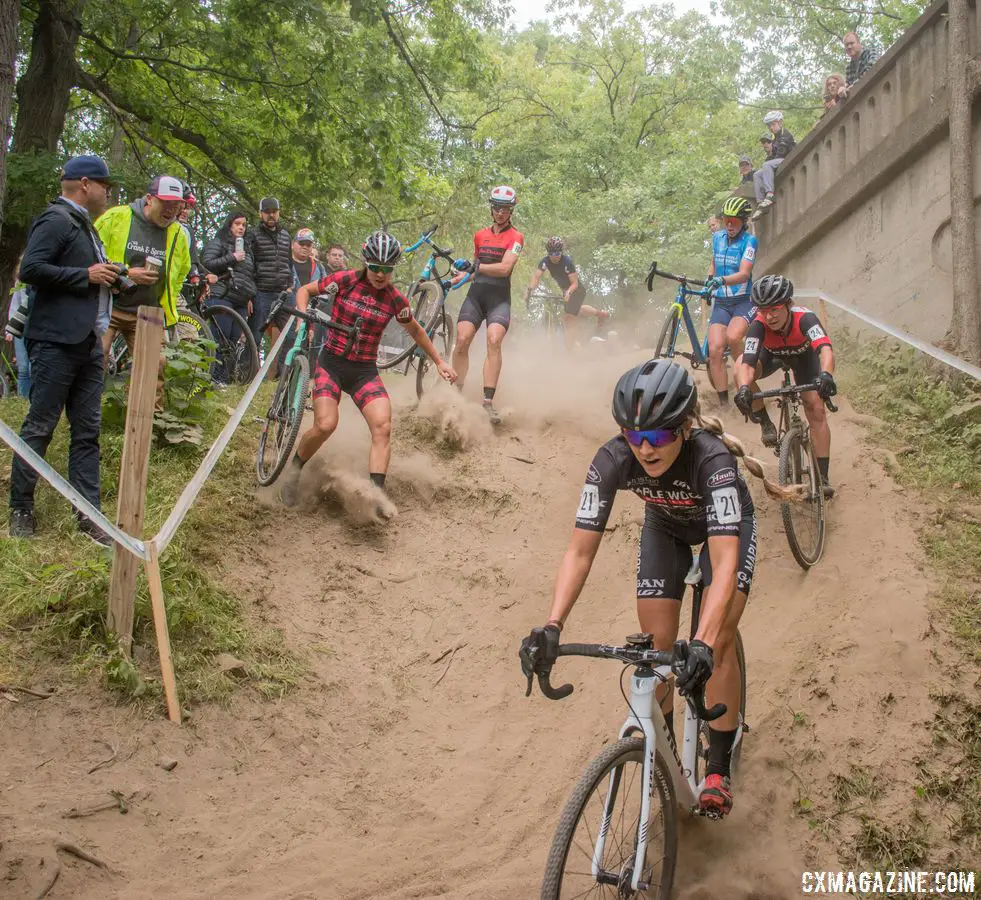 Raylyn Nuss leads the way down one of the technical descents while riders pick different ways of handling the feature. 2018 Rochester Cyclocross. © Evan Grucela