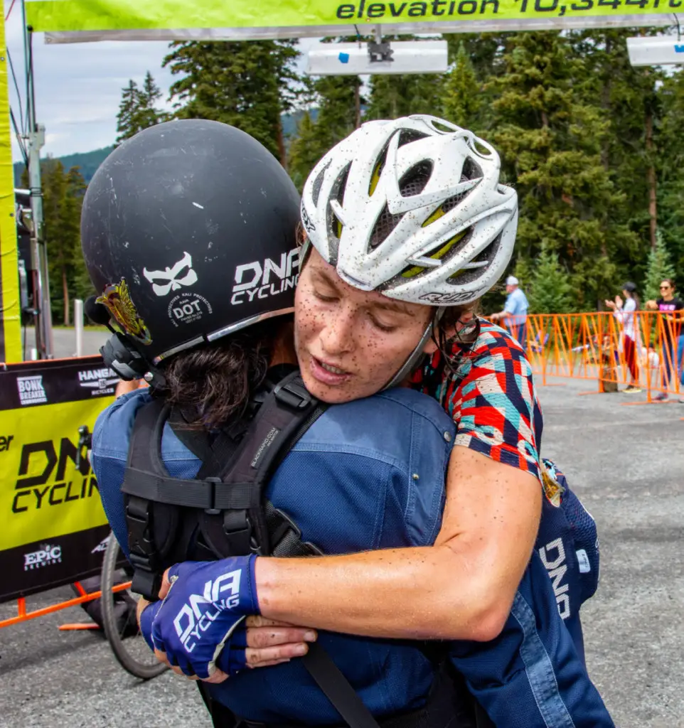 Catherine Fegan-Kim, co-owner of the DNA Cycling Women's Team, hugs Women's Open winner Lauren DeCrescenzo just after the finish line at Eagle Point Resort. 2018 Crusher in the Tusher. photo: Steven Sheffield