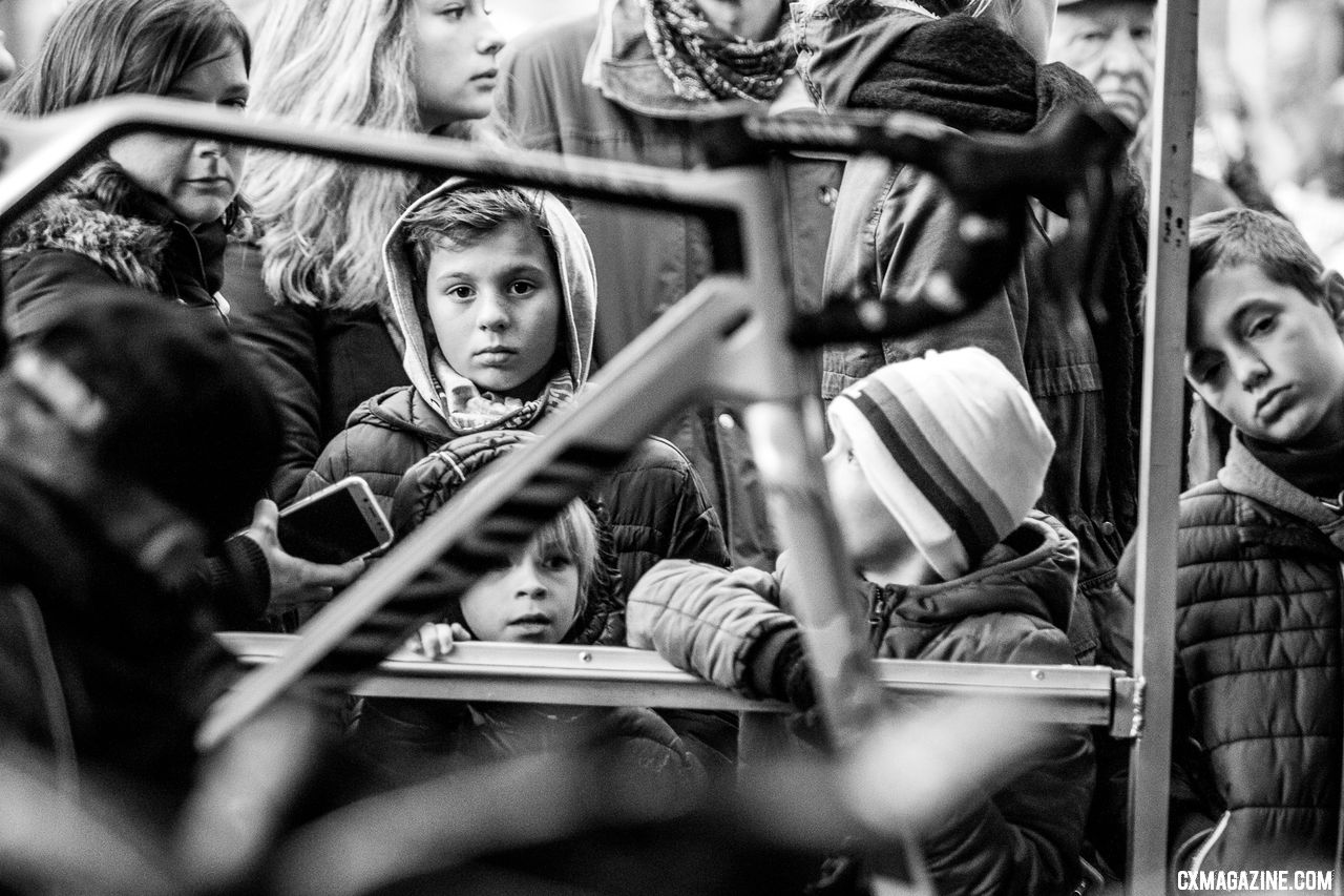 Fans of all ages wait for a Mathieu van der Poel appearance, while his mechanic cleans up from the day's effort. 2018 Superprestige Gavere. © A. Yee / Cyclocross Magazine