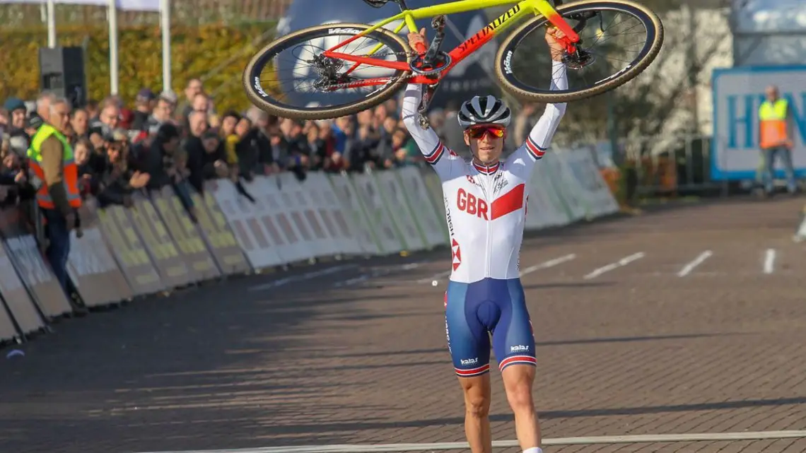 Tom Pidcock hoists his Specialized CruX after winning the U23 Men's race. 2018 European Cyclocross Championships, Rosmalen, Netherlands. © B. Hazen / Cyclocross Magazine