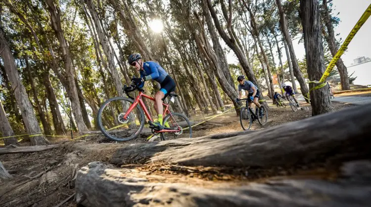 Riders go over an obstacle. 2018 Coyote Point Cyclocross Race 1, San Mateo, California. © J. Vander Stucken / Cyclocross Magazine