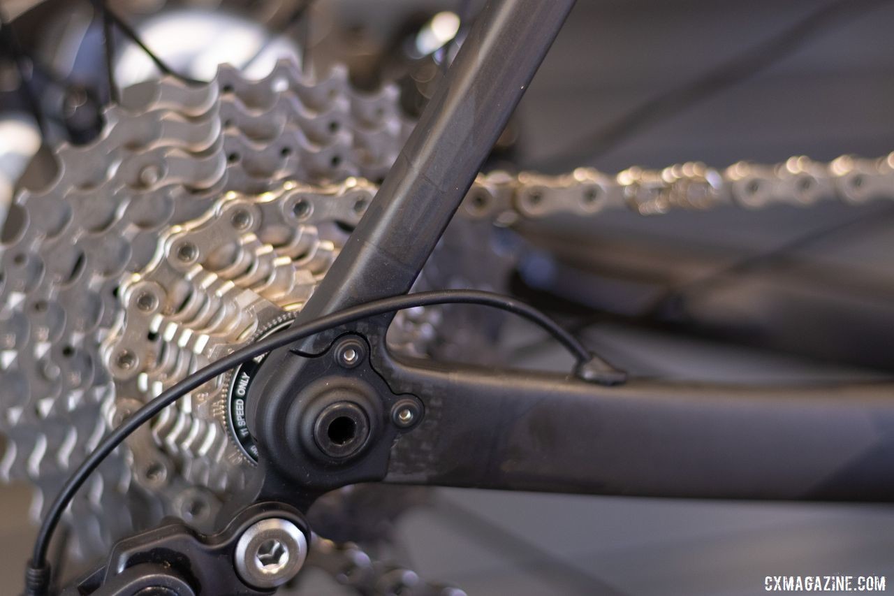 A small, replaceable derailleur hanger pairs with the thru-axle dropout like a jigsaw puzzle piece. Crumpton's carbon gravel bike. 2019 NAHBS Sacramento. © A. Yee / Cyclocross Magazine