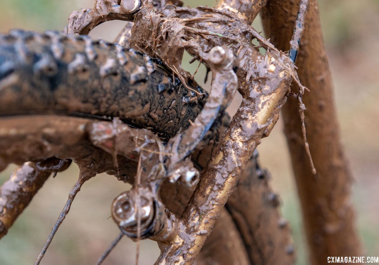 The wishbone stay partially obscured by mud in this image is a feature of SyCip frames. Vida Lopez de San Roman's Sycip cyclocross bike. 2018 Cyclocross National Championships V2. Louisville, KY. © Cyclocross Magazine
