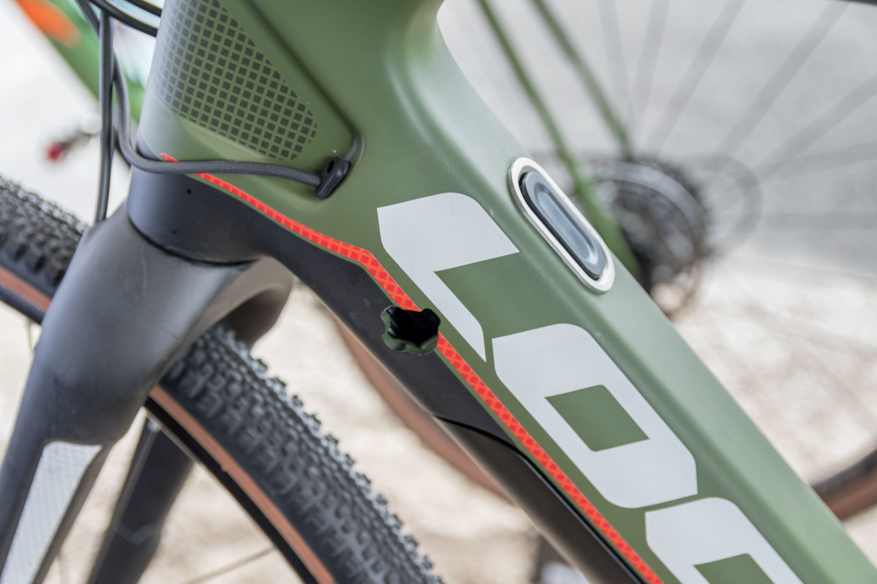 The hole is for a lock to hold the downtube batter in place, the button releases the battery and motor pack. Look E-765 Gravel RS Gravel Bike, 2019 Sea Otter Classic. © C. Lee / Cyclocross Magazine