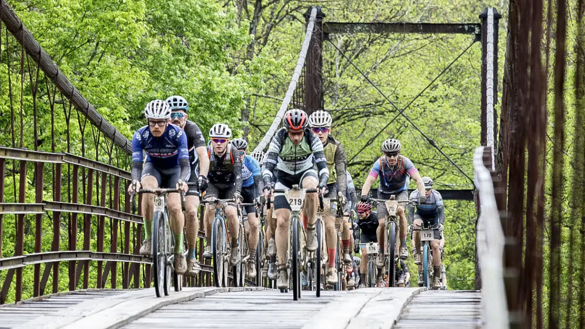 Riders make their way over a bridge during The Epic. 2019 The Epic Gravel Race, Missouri. © Studio T Images