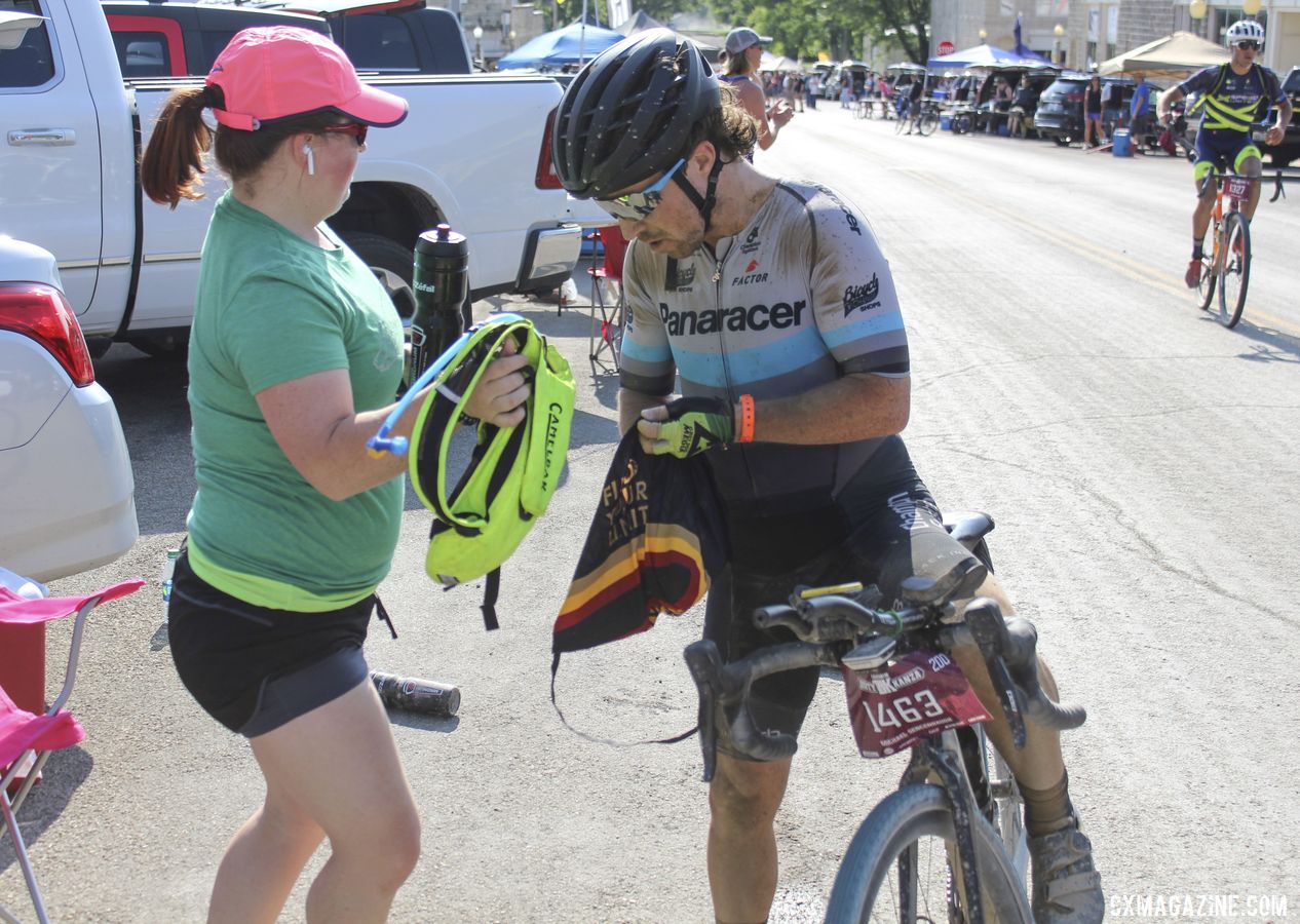 Jane Sencenbaugh helps Michael get a hydration pack and a new water bottle. 2019 Dirty Kanza 200, Panaracer / Factor p/b Bicycle X-Change Checkpoint 1. © Z. Schuster / Cyclocross Magazine