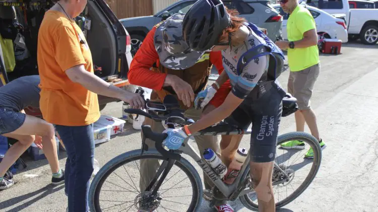 Dan Szokarski helps restock Takeshita's top tube bag while Becky Cummings helps hold her bike. 2019 Dirty Kanza 200, Panaracer / Factor p/b Bicycle X-Change Checkpoint 1. © Z. Schuster / Cyclocross Magazine