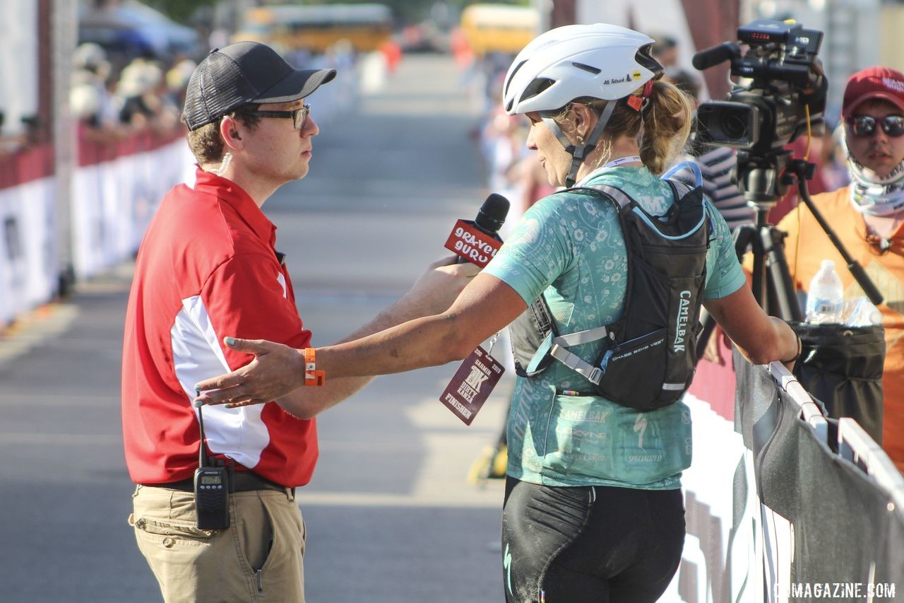 Tetrick, here being interviewed by Gravel Guru's Matt Fowler, has become a DK institution. 2019 Women's Dirty Kanza 200 Gravel Race. © Z. Schuster / Cyclocross Magazine