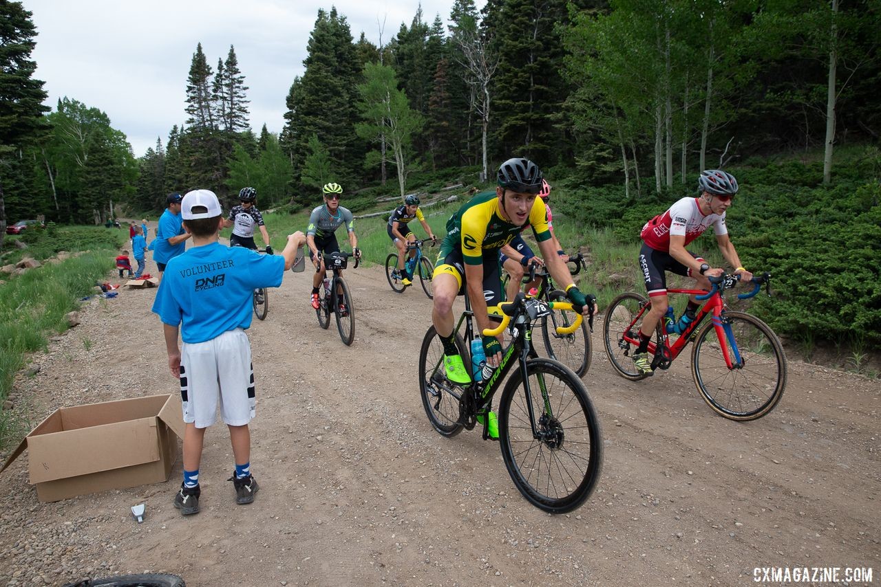 Gage Hecht gets a fresh bottle from the volunteers. 2019 Crusher in the Tushar Gravel Race. © Cathy Fegan-Kim / Cottonsox Photo