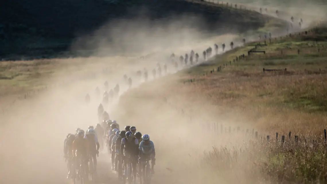 The field rolls down a dusty gravel road. 2019 SBT GRVL gravel race. © Wil Matthews