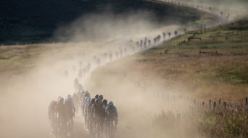 The field rolls down a dusty gravel road. 2019 SBT GRVL gravel race. © Wil Matthews