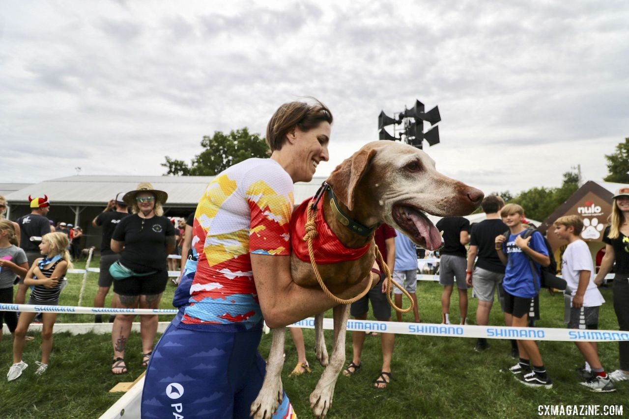 Sunny Gilbert carries Gunnar over the barriers. 2019 Doggy Cross, Jingle Cross World Cup. © D. Mable / Cyclocross Magazine