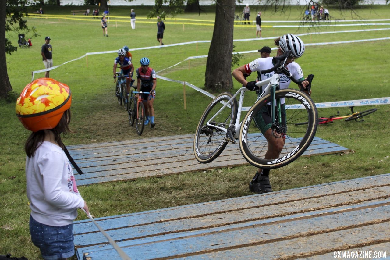 A young fan cheers Kaitie Keough and the other chasers on. 2019 Rochester Cyclocross Day 1. © Z. Schuster / Cyclocross Magazine