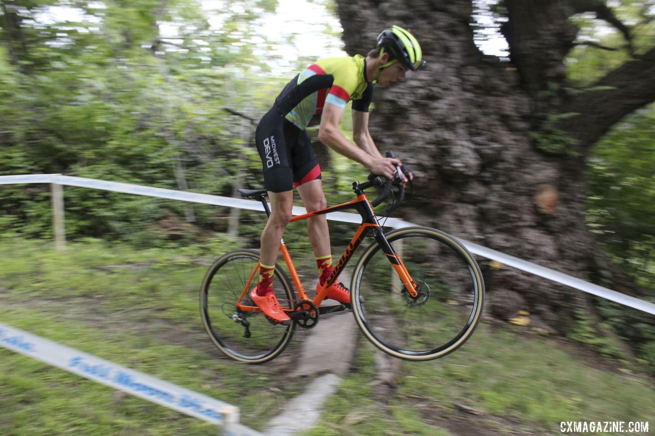 A Midwest Devo rider gets rad over the granite slab. 2019 Rochester Cyclocross Friday Pre-Ride. © Z. Schuster / Cyclocross Magazine