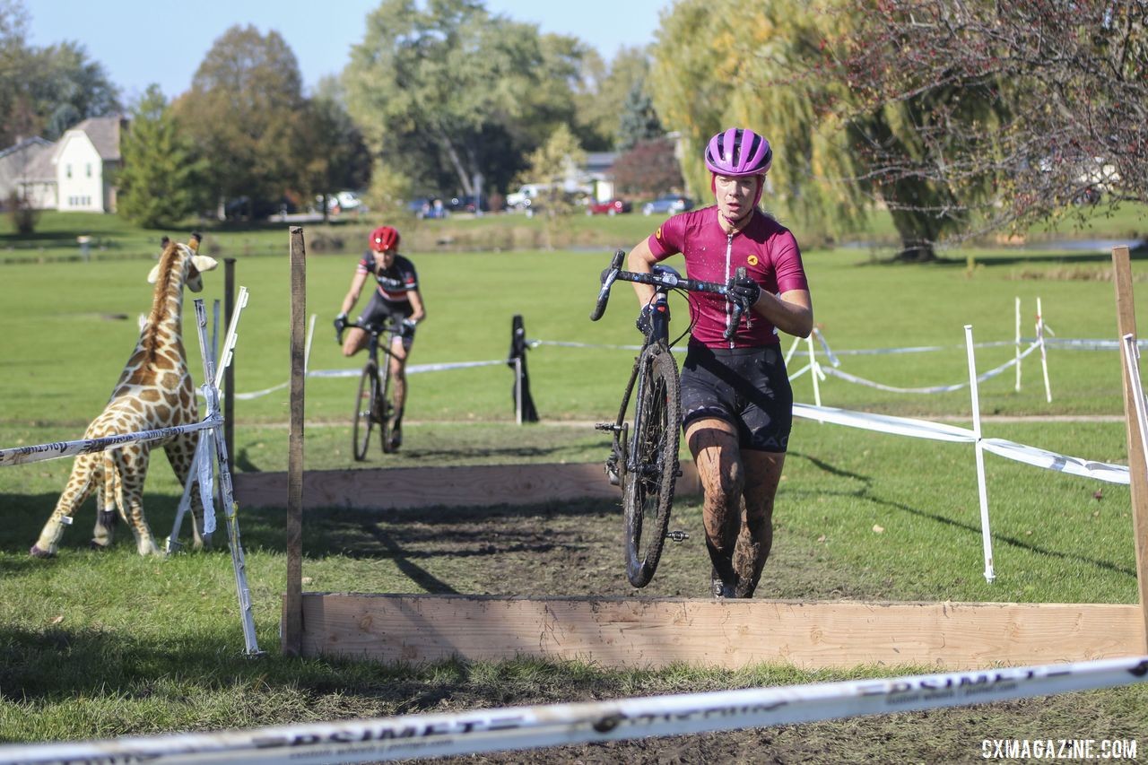 Sydney Guagliardo hits the barriers in Lap 3 with April Beard close behind. 2019 Sunrise Park Cyclocross, Chicago Cross Cup. © Z. Schuster / Cyclocross Magazine