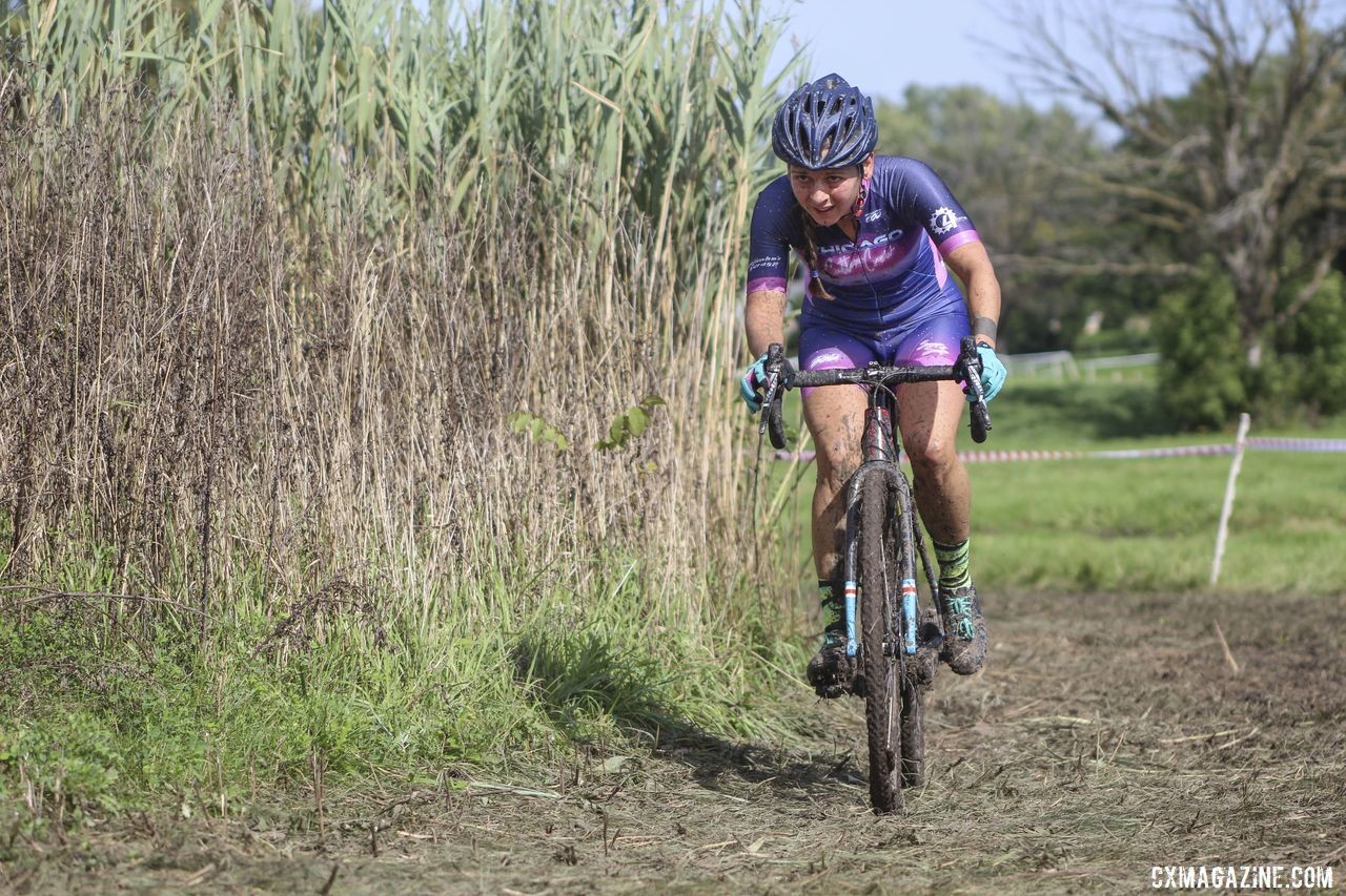 Mary Randall rides the line of bushes to get through one of the bigger mud pits. 2019 CCC Hopkins Park CX at Indian Lakes. © Z. Schuster / Cyclocross Magazine