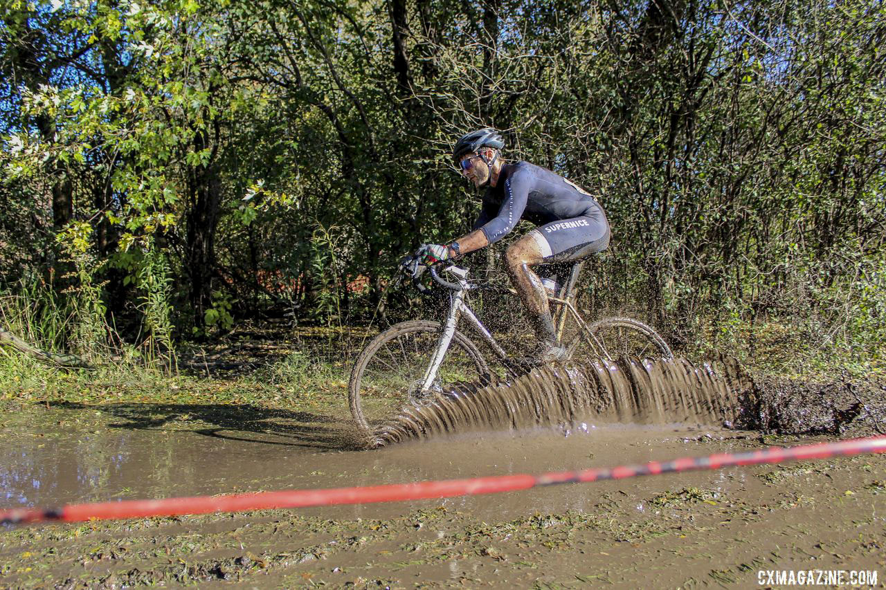 Travis Braun sent one of the water features cascading around him. 2019 Sunrise Park Cyclocross, Chicago Cross Cup. © Z. Schuster / Cyclocross Magazine