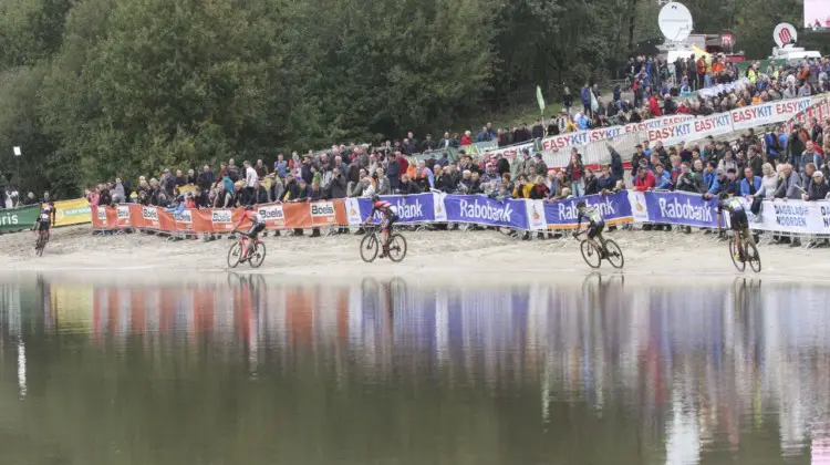 Riders pass along the Gieten lake. 2019 Superprestige Gieten. © B. Hazen / Cyclocross Magazine