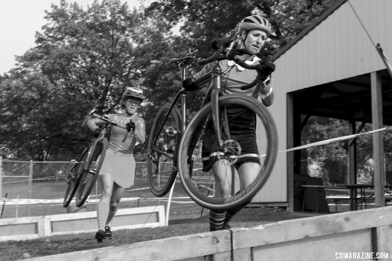 April Beard and Holly LaVesser run the barriers. 2019 Cross Fire Halloween Race, Wisconsin. © Z. Schuster / Cyclocross Magazine